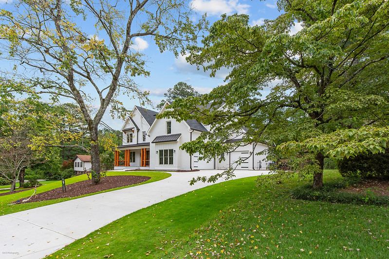 White farmhouse-style custom home with a long curved driveway, Brookcliff new custom home, Marietta, GA