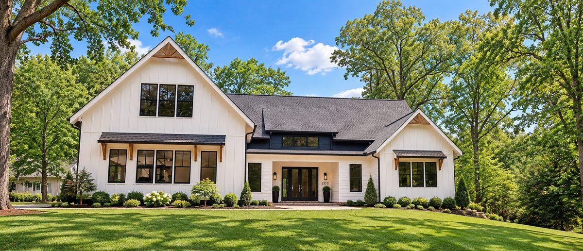 Front exterior of white modern farmhouse with landscaping, Penhurst new custom home, Roswell, GA