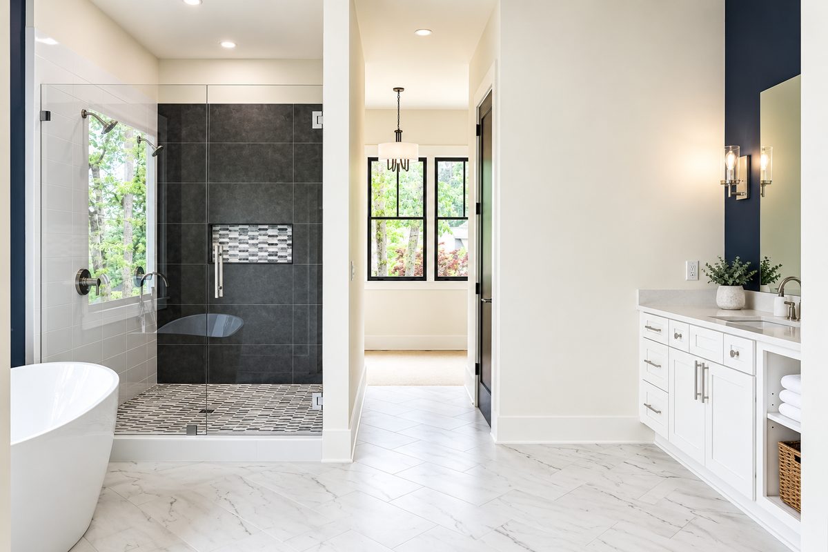 Primary bath with freestanding tub, black tile shower and white vanity, Penhurst new custom home, Roswell, GA