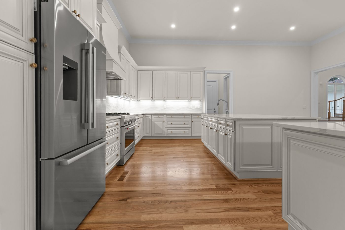 Kitchen with stainless refrigerator and white cabinetry, Henderson Mill new custom home, DeKalb County, GA