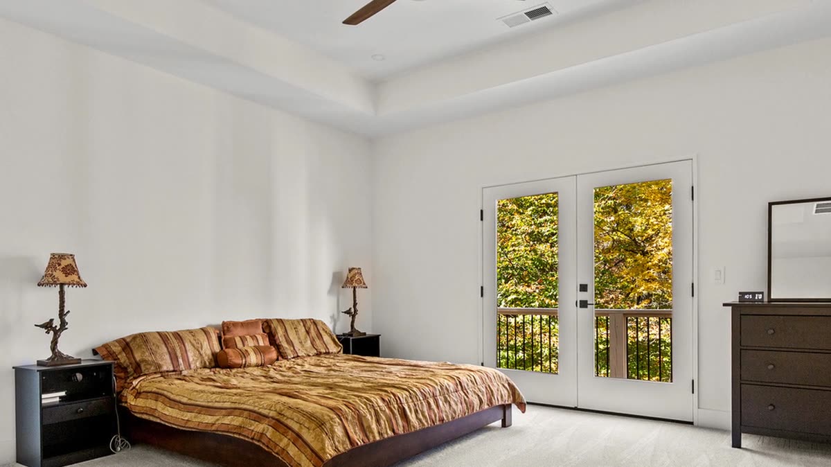 Primary bedroom with tray ceiling and French doors to a balcony, Old Orchard new custom home, Marietta, GA