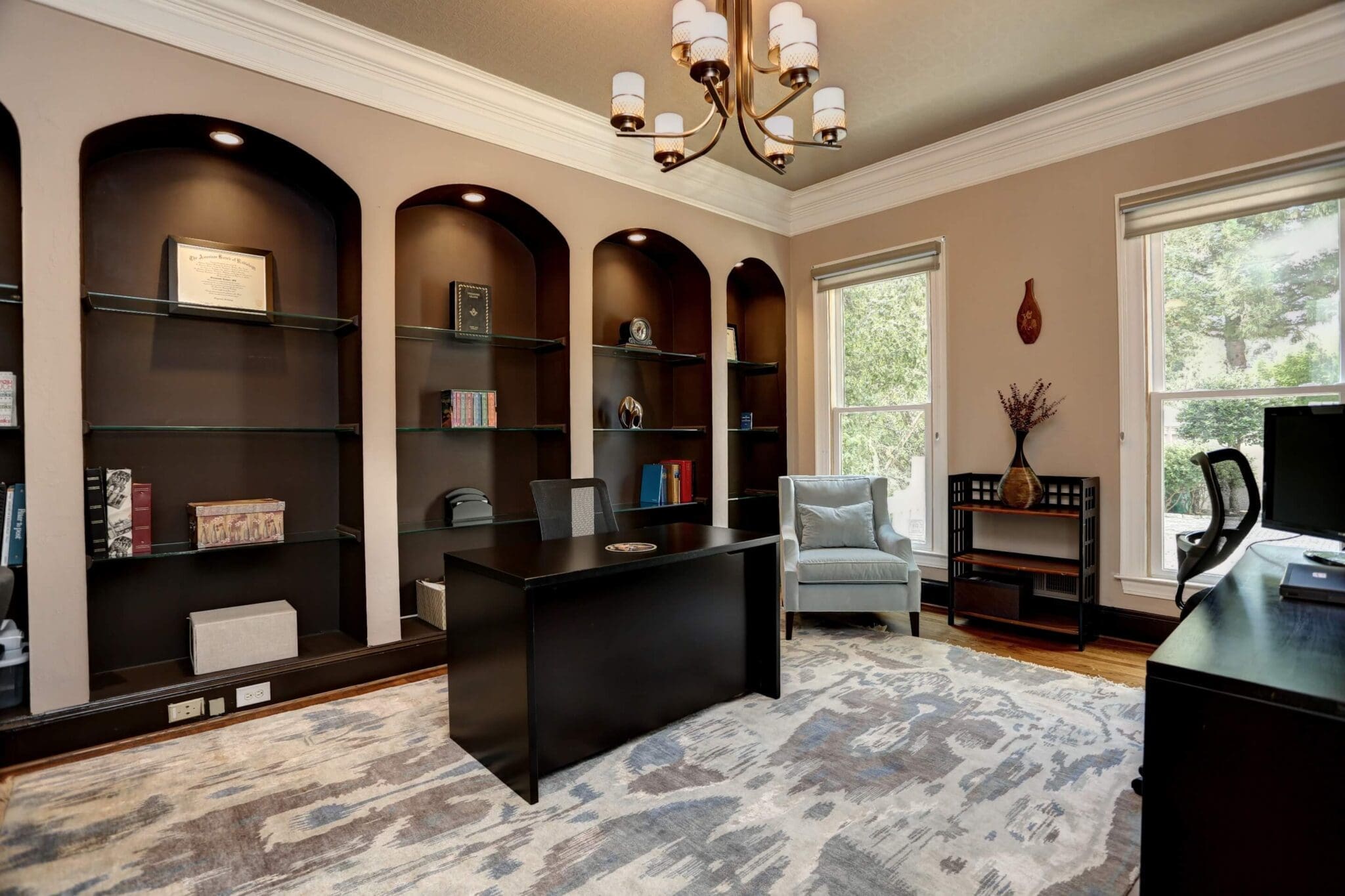A room with many bookcases and a desk