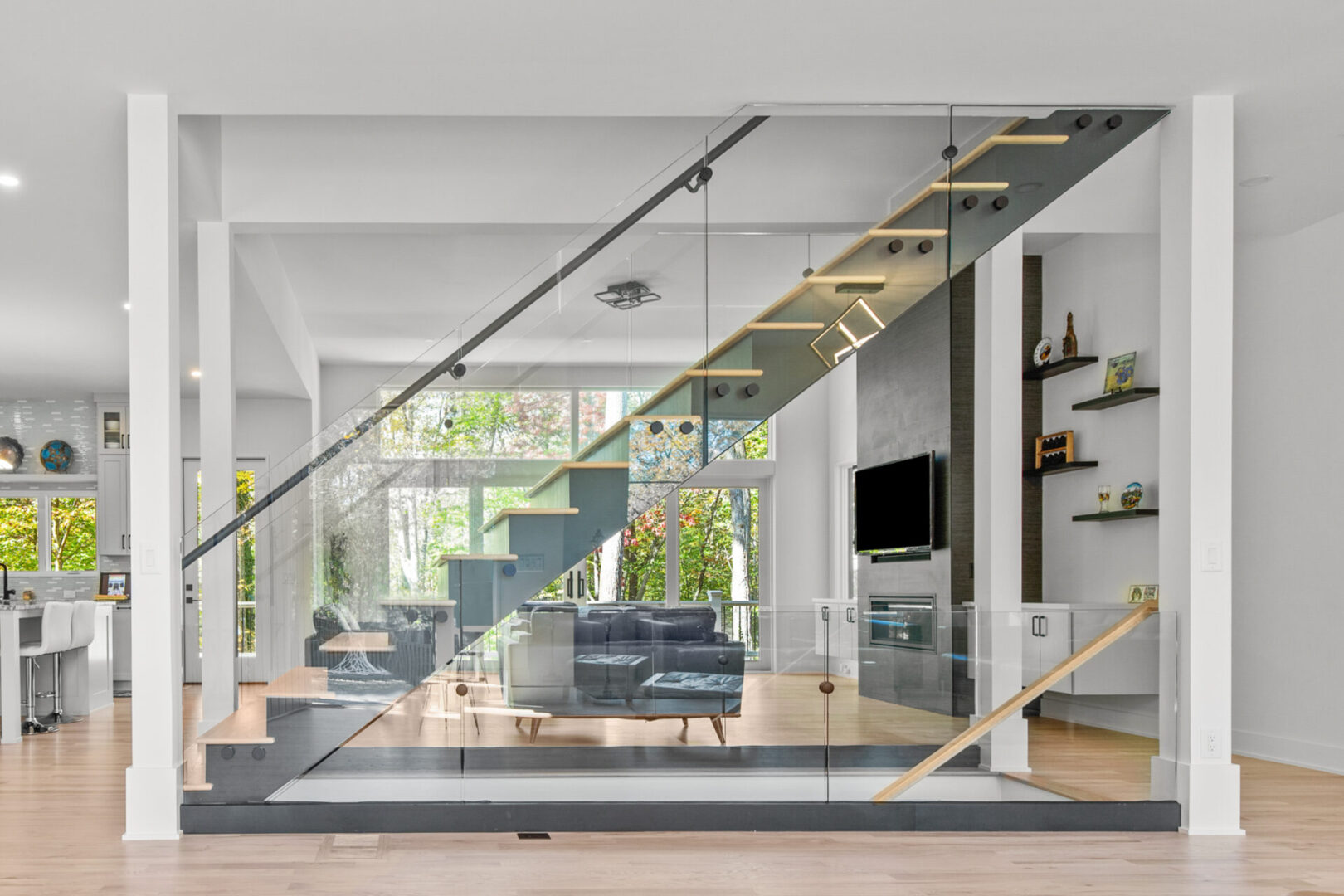 A living room with glass stairs and a couch