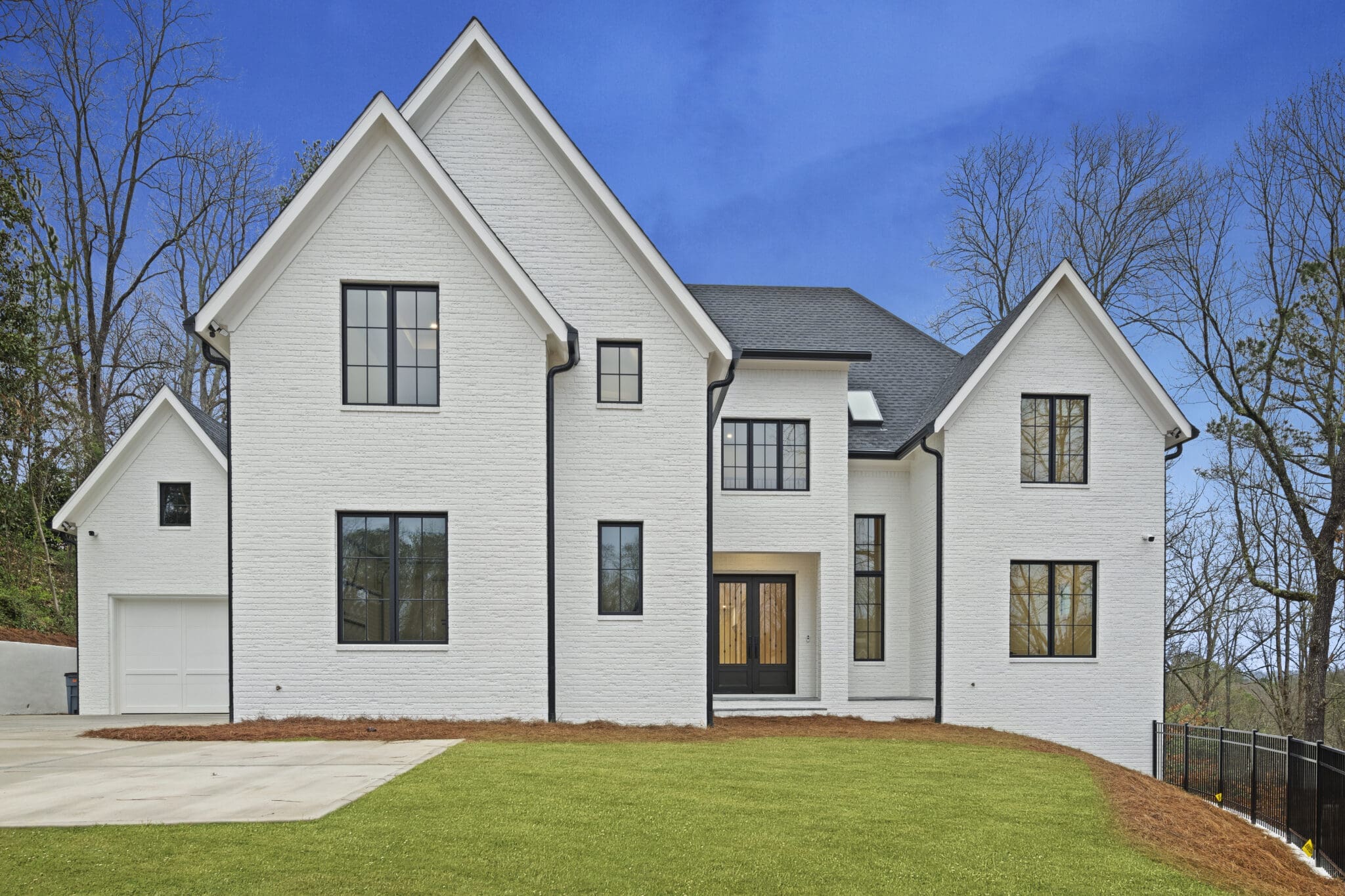 A large white house with black windows and doors.