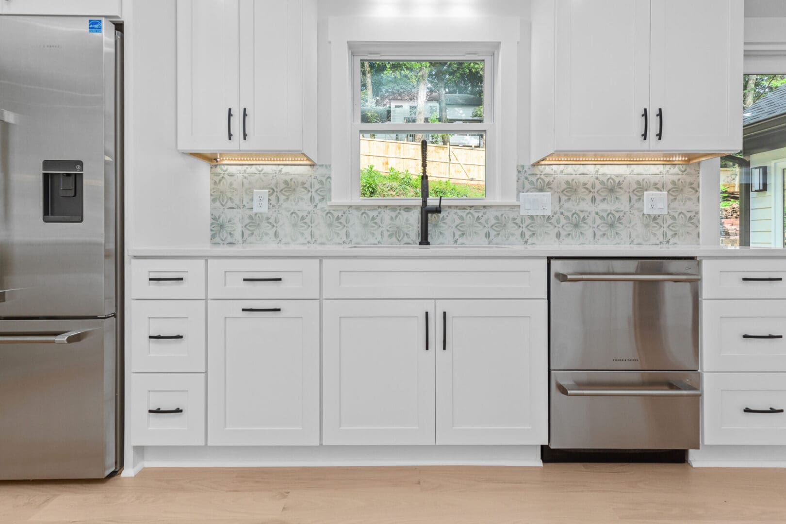 White kitchen with stainless steel appliances.
