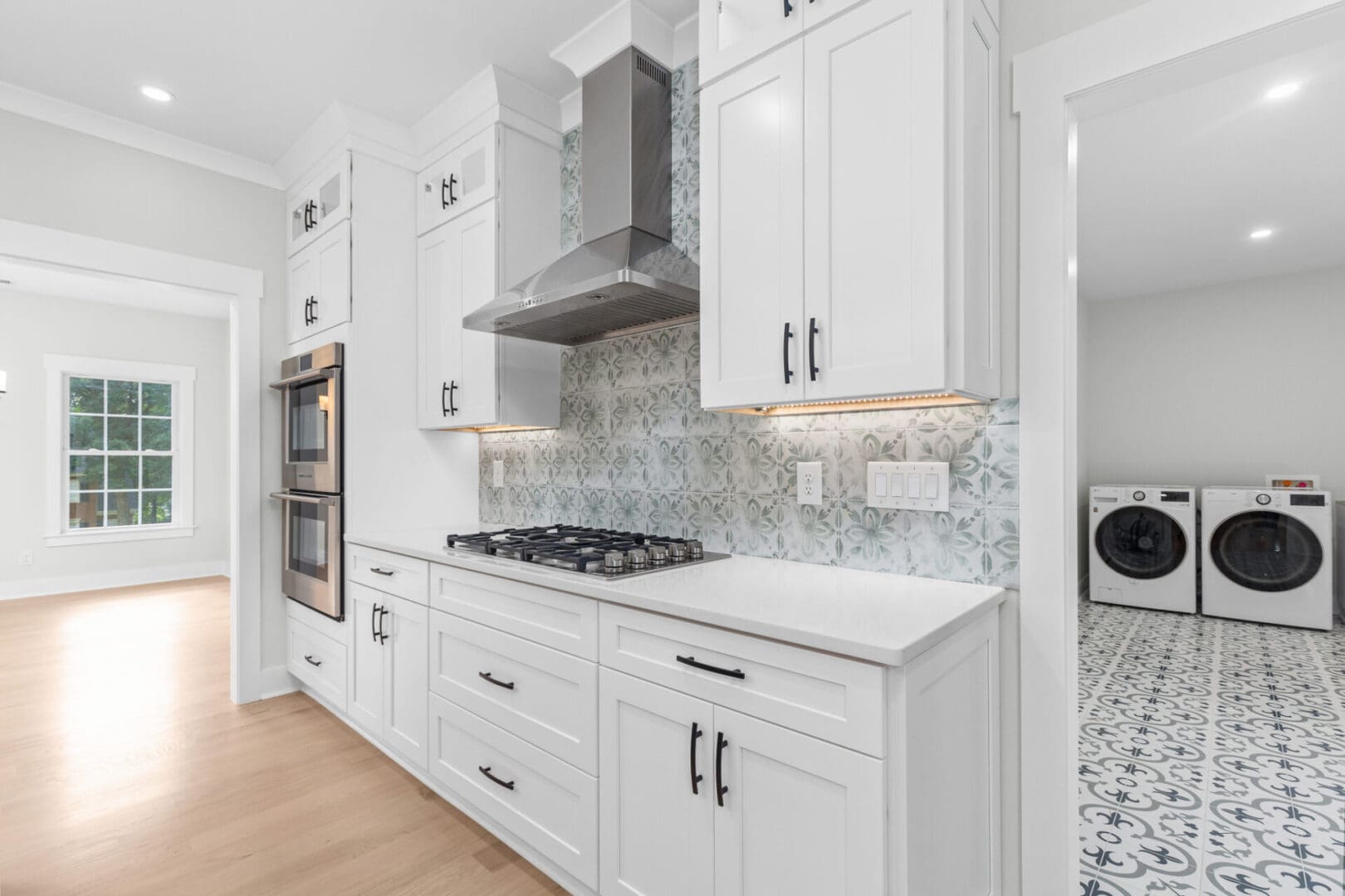 White kitchen with stainless steel appliances.