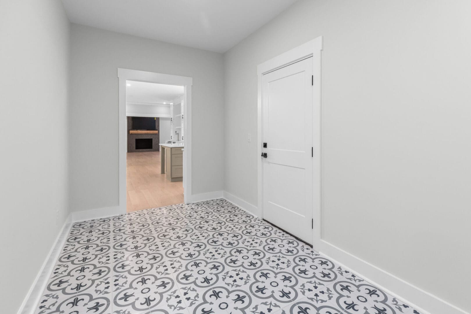 White door and patterned tile floor.