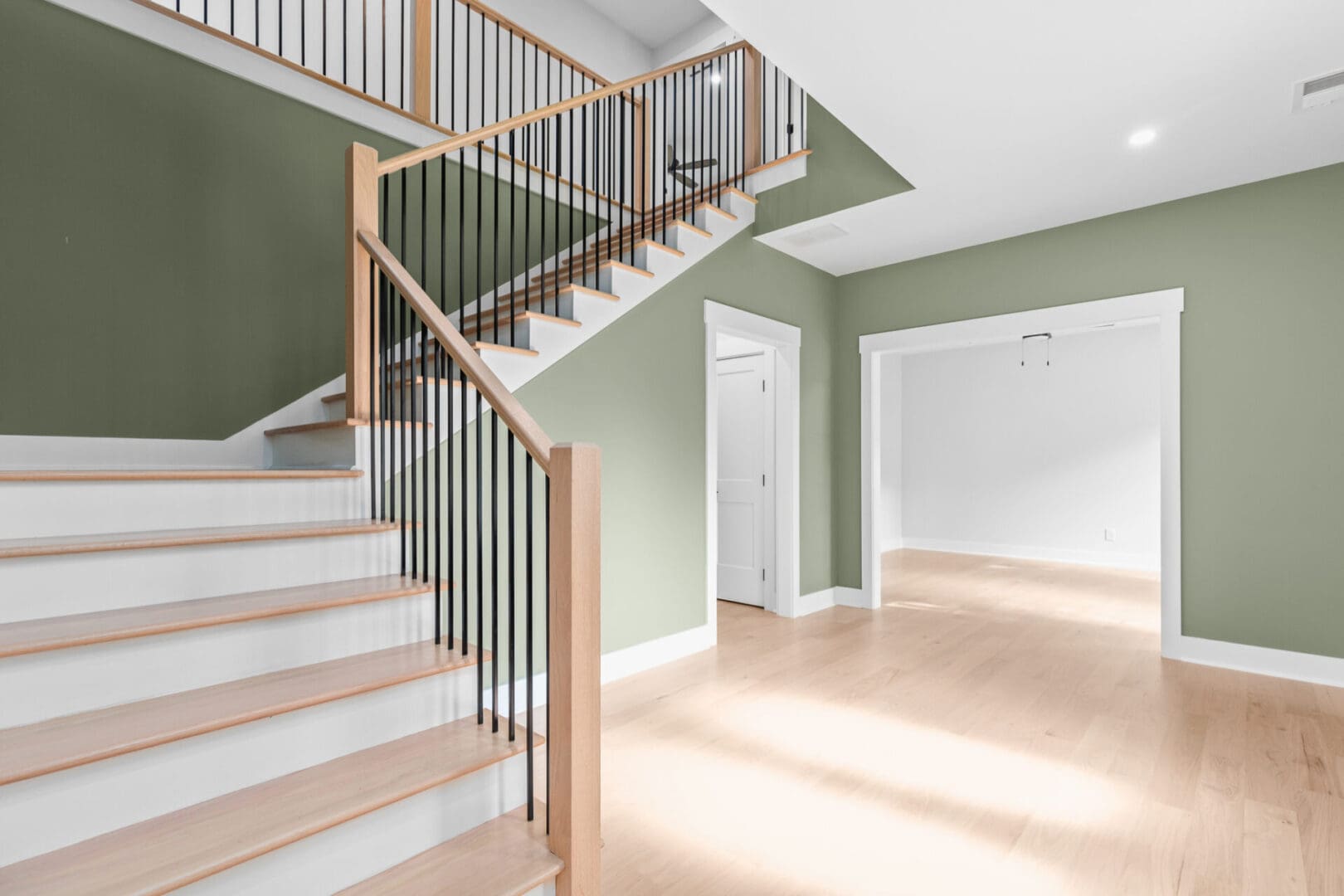 Modern staircase with black railing.