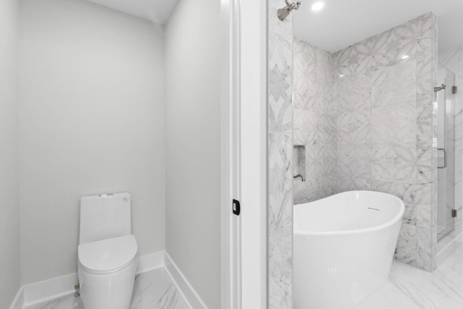 White toilet and bathtub in a bathroom.