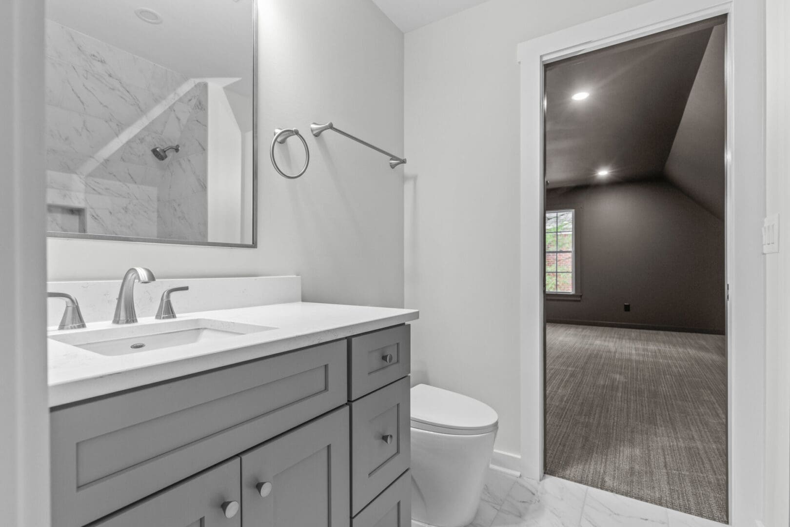 Bathroom vanity with grey cabinets and sink.