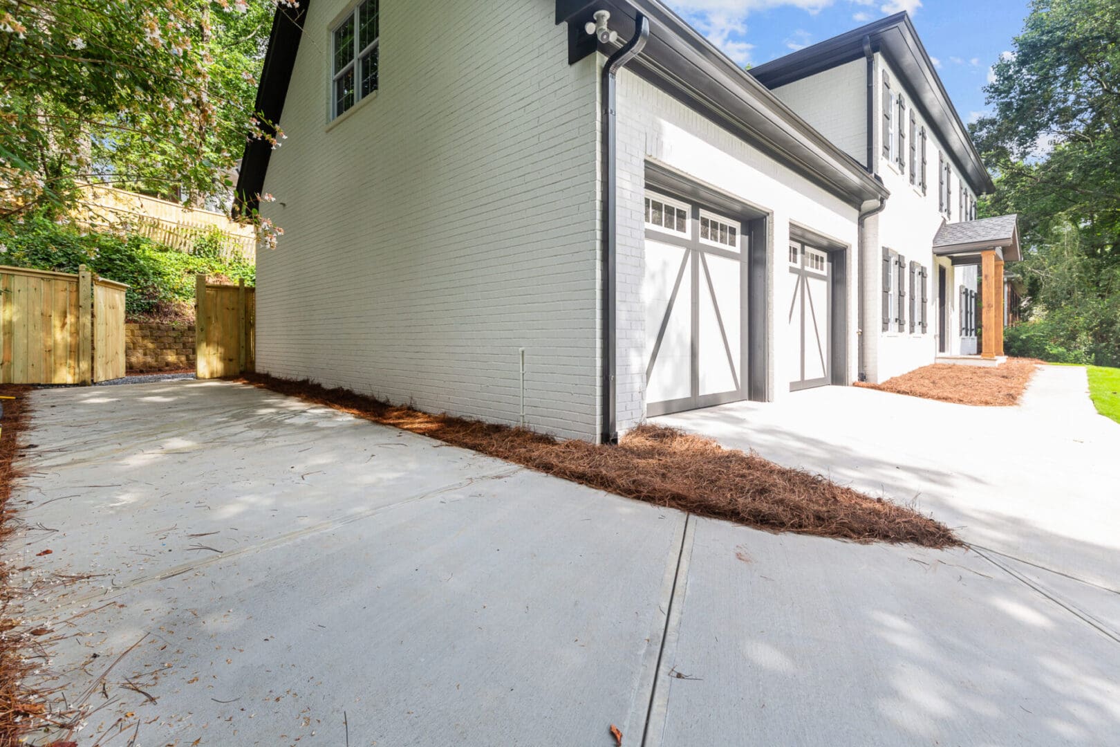 White house with two garage doors.