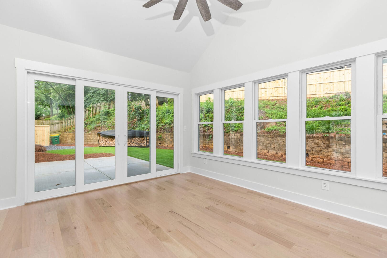 Light hardwood floor with sliding doors to yard.