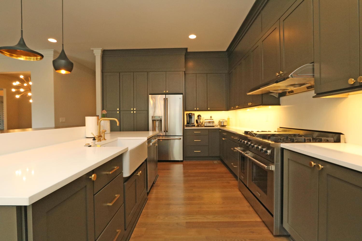 Modern kitchen with dark green cabinets.