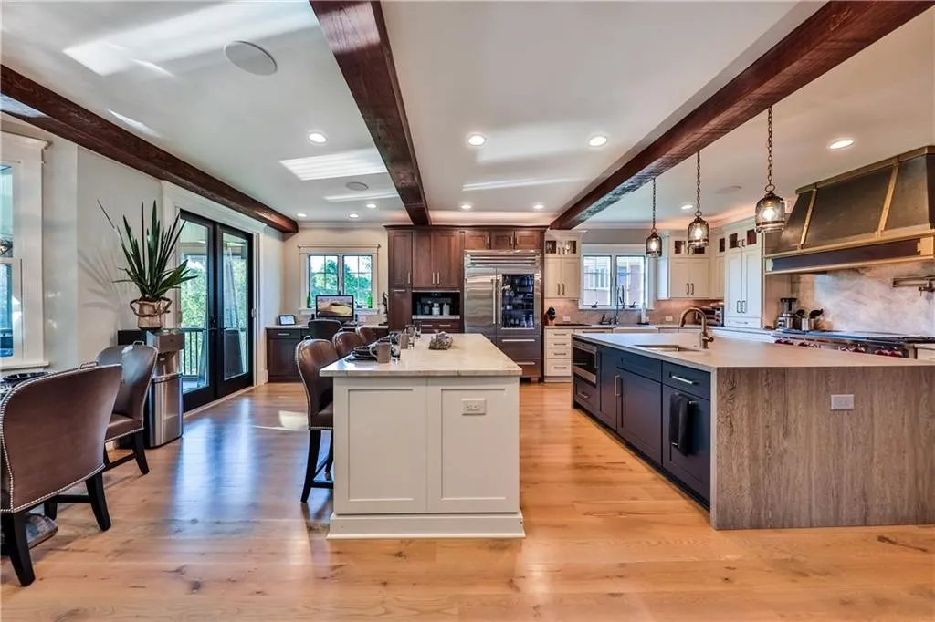 Modern kitchen with wood beams and island.