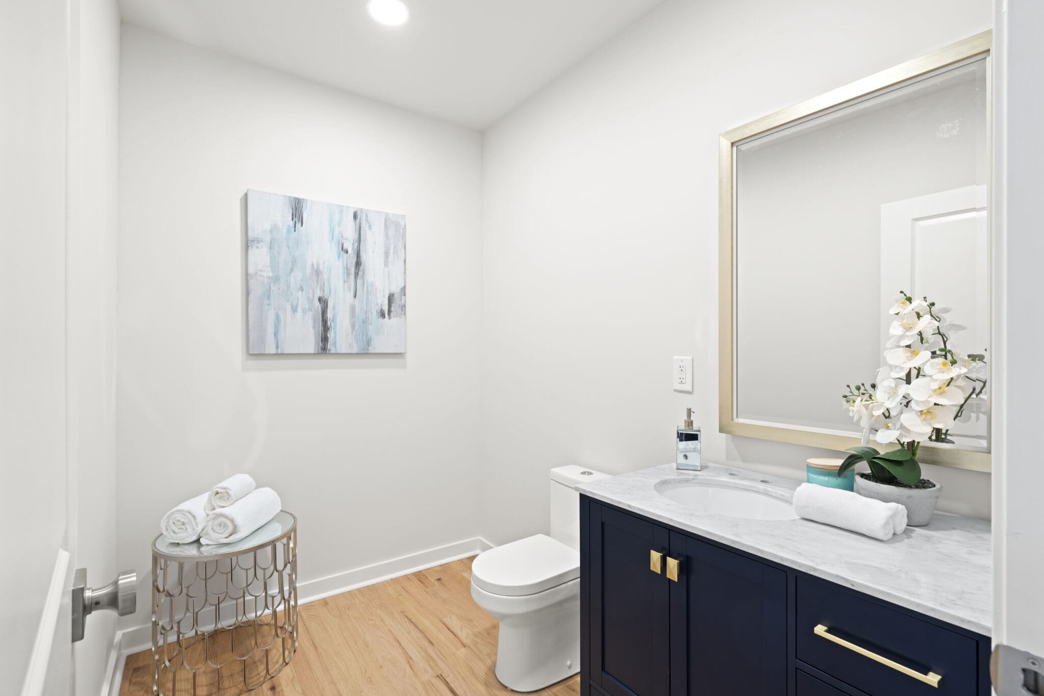 Modern bathroom with white towels and orchids.