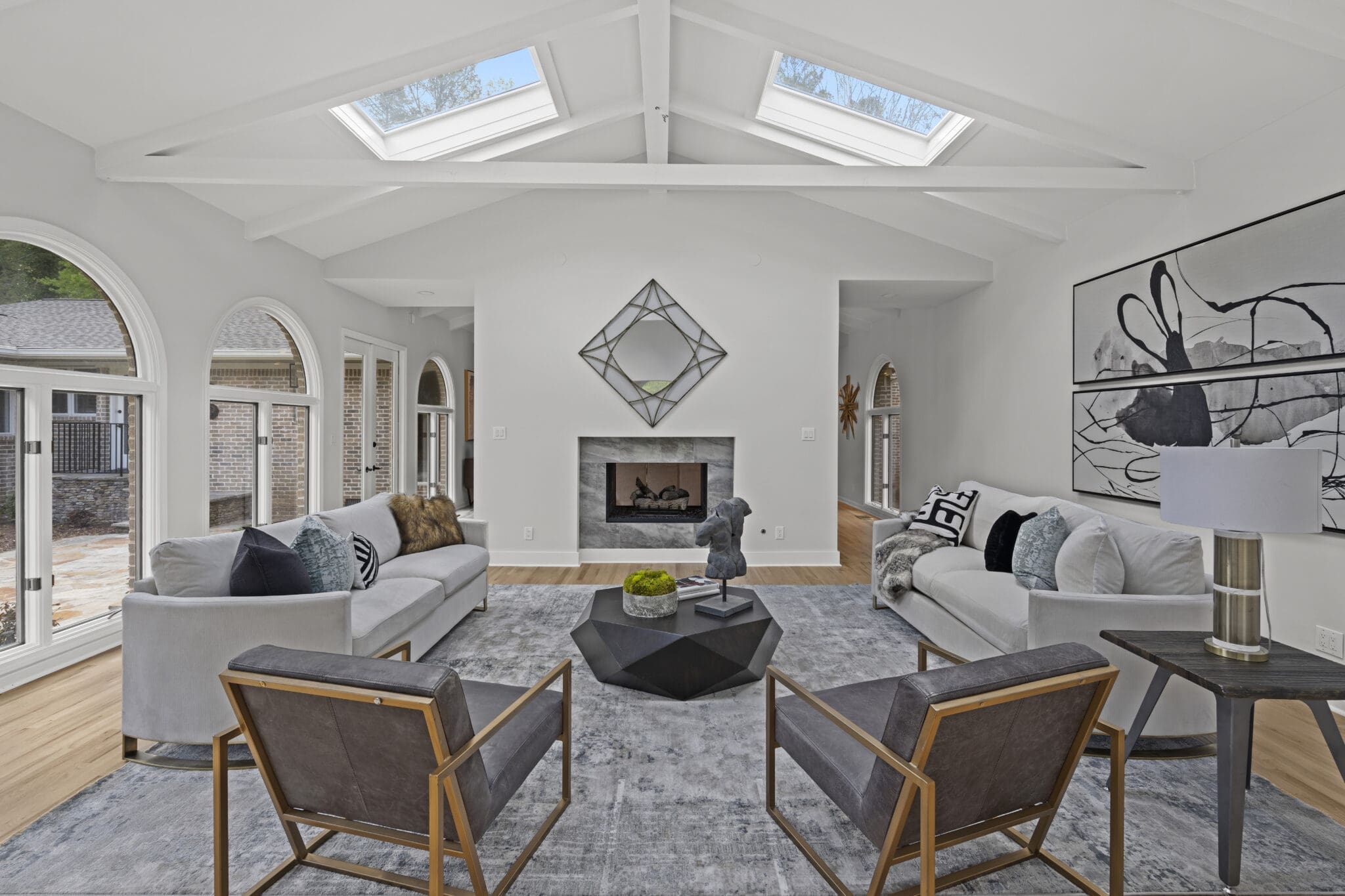 Modern living room with fireplace and skylights.