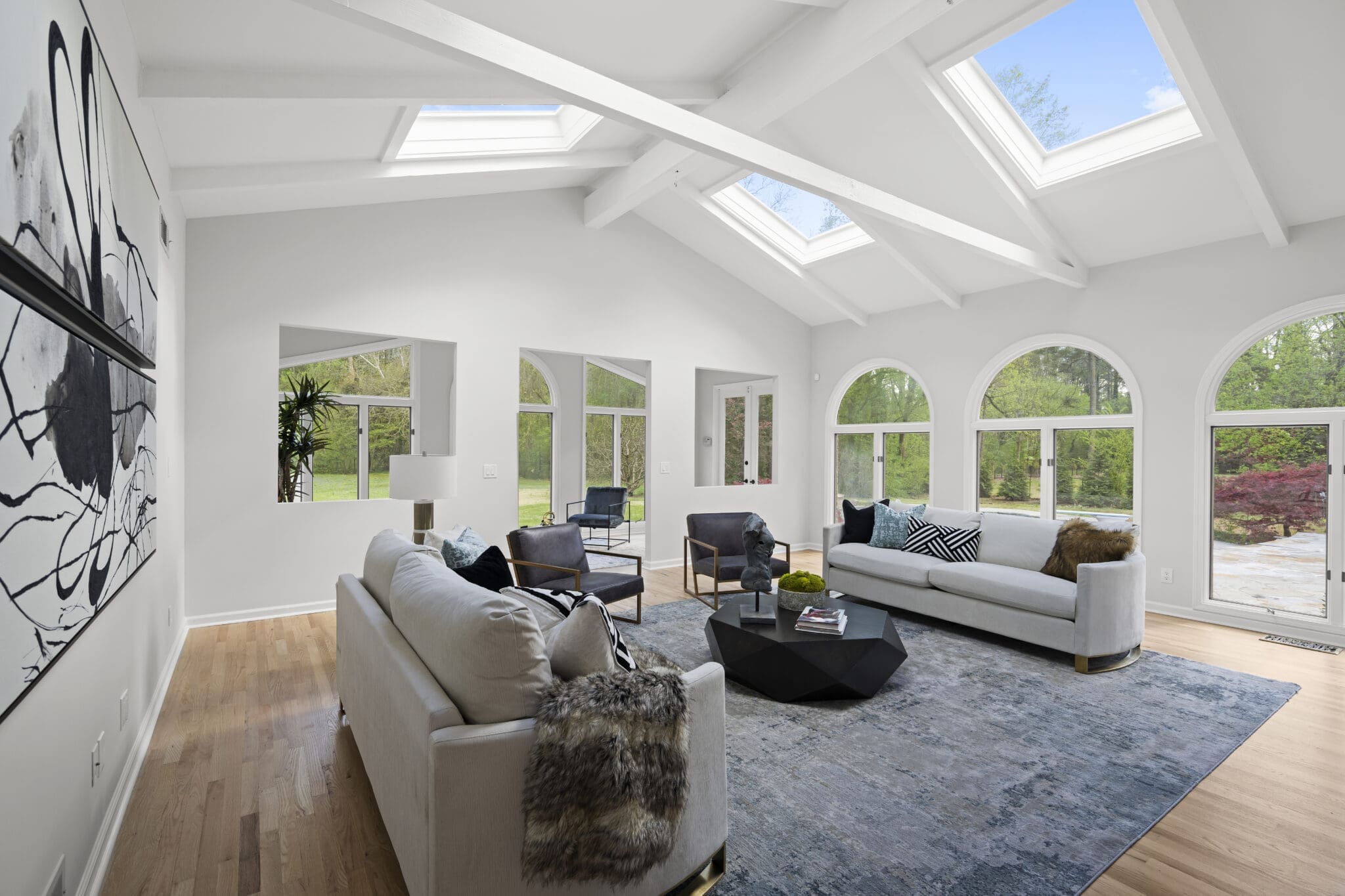 Modern living room with skylights and large windows.