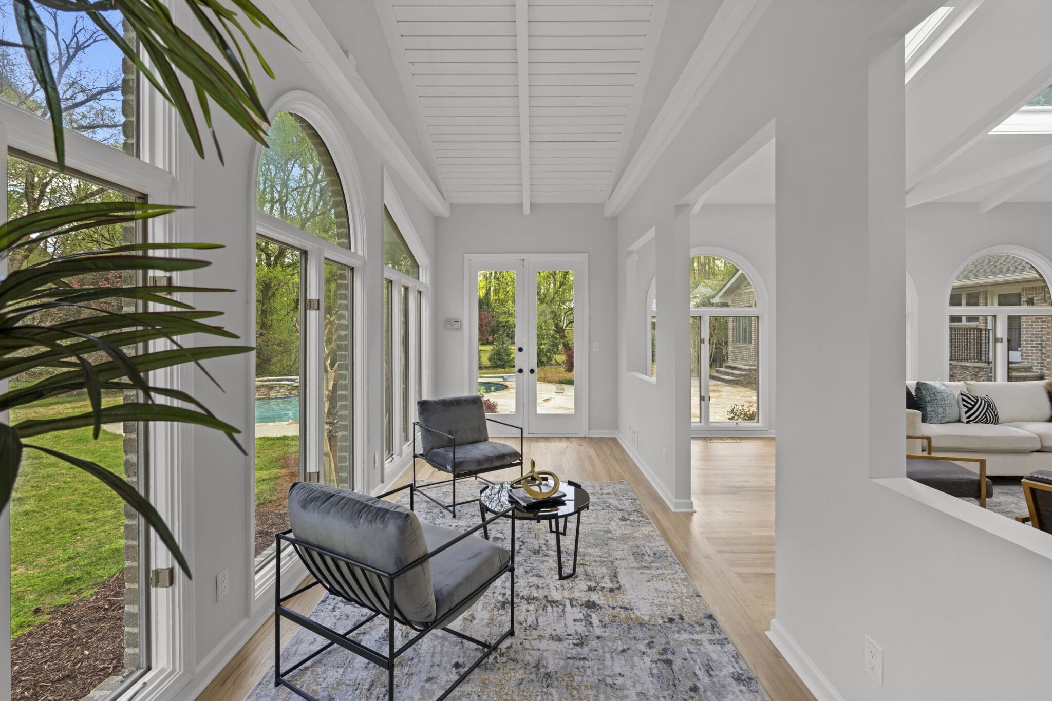 Sunroom with two chairs and a view.