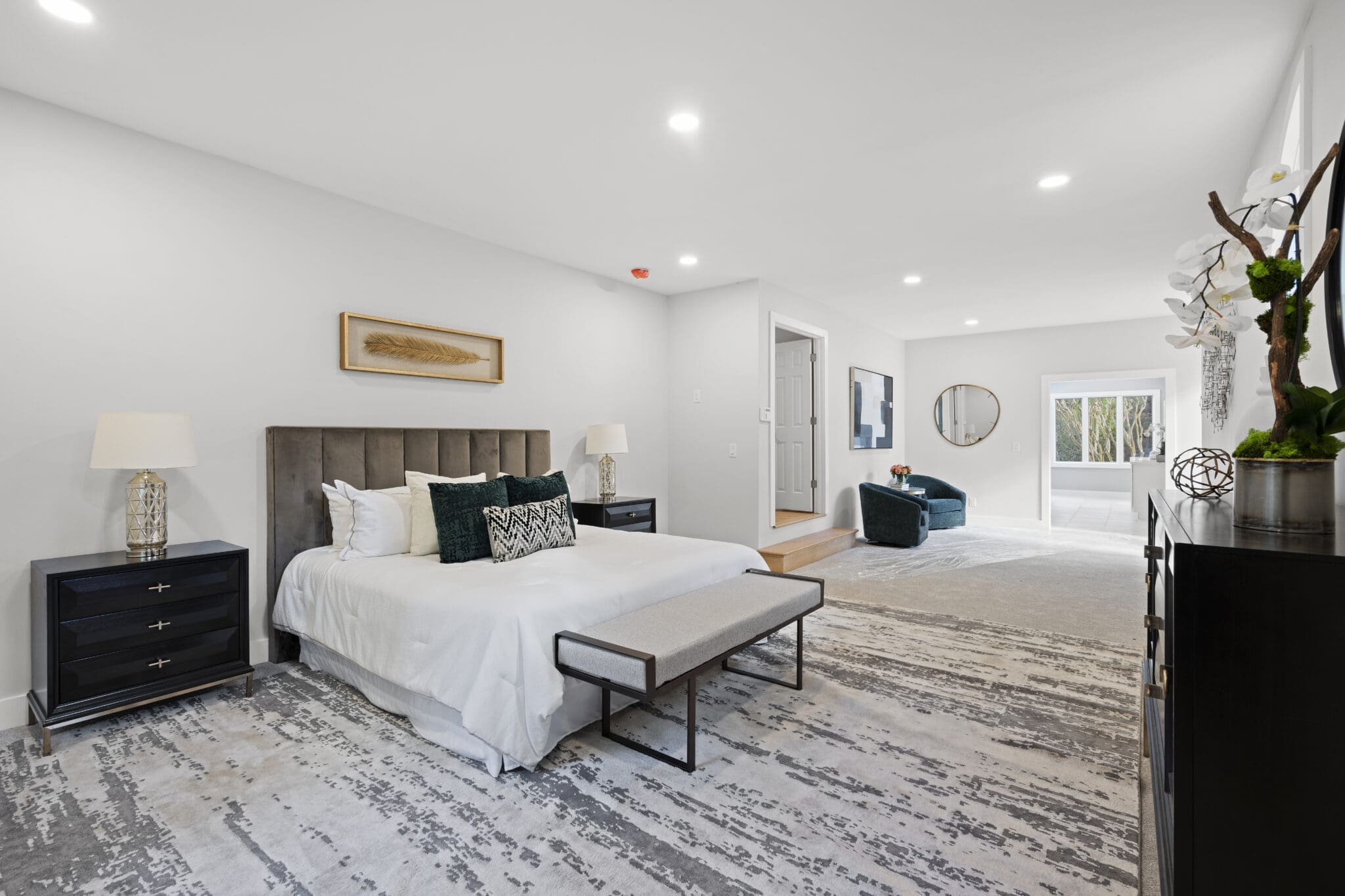 Modern bedroom with a plush bed and rug.