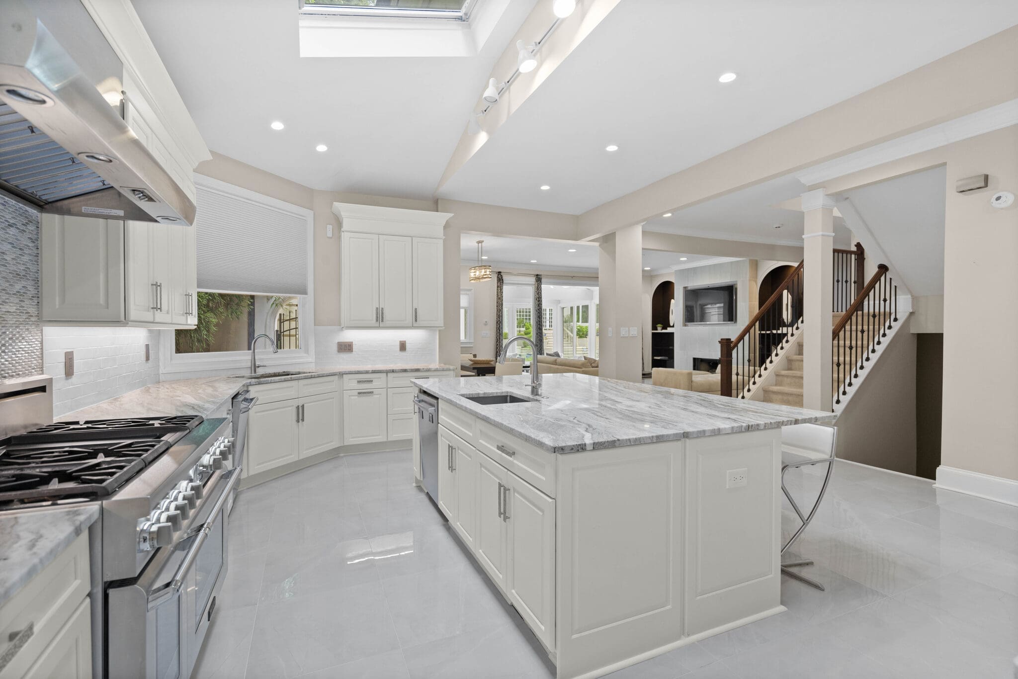 Modern kitchen with white cabinets and island.