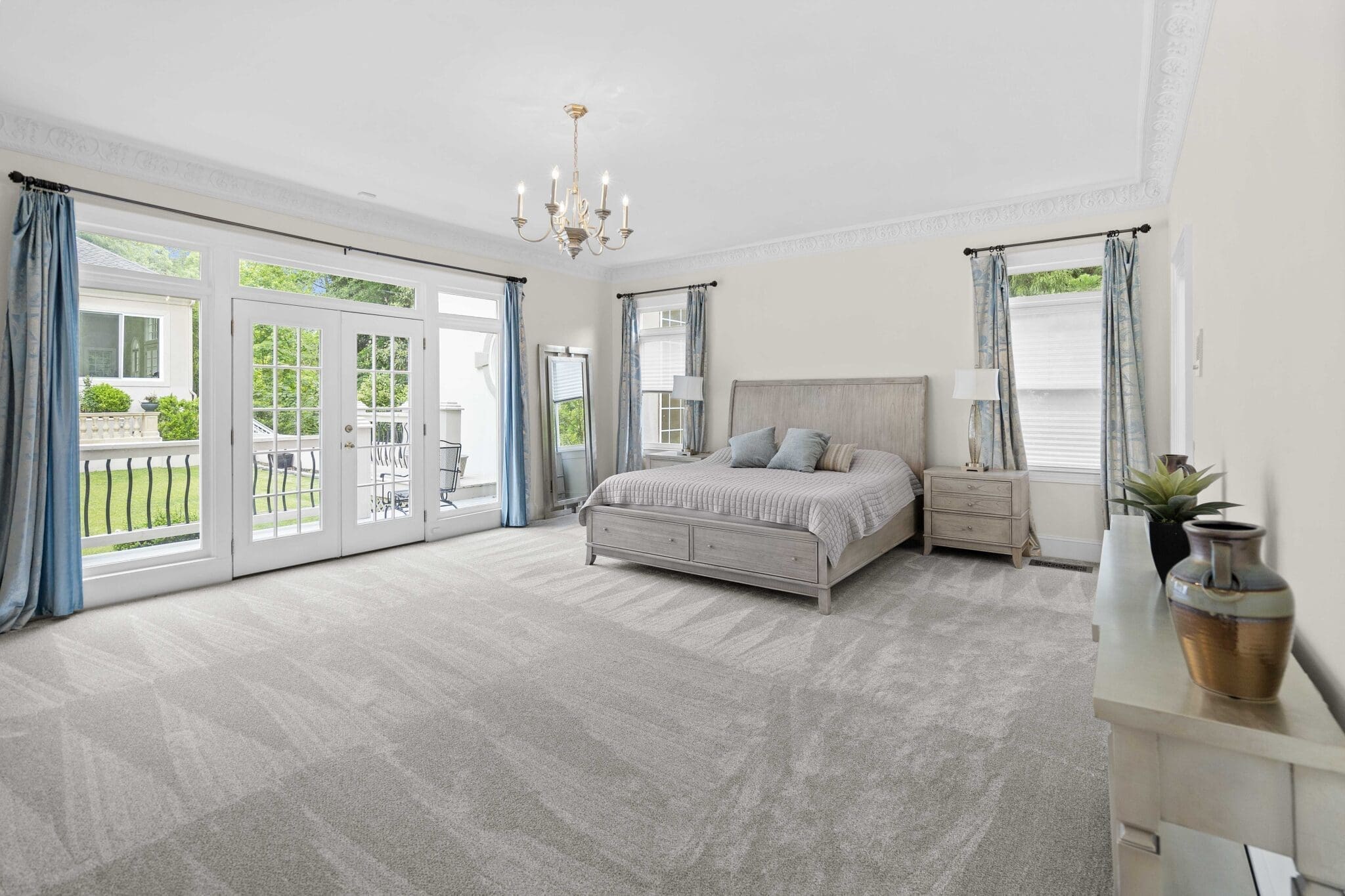 Bedroom with a bed and a large window.